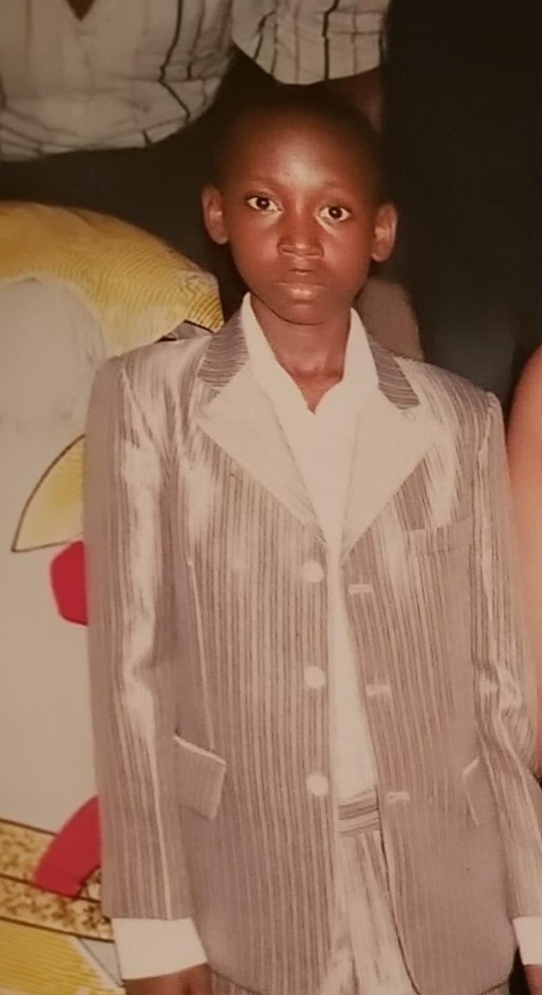 Lumiere as a child wearing a suit